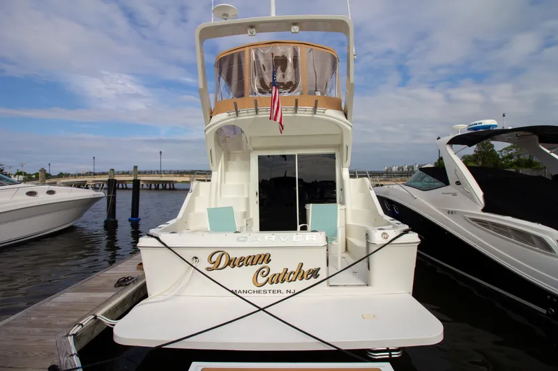 Slide: The Image of The 2006 Carver 33 Super Sport is docked, featuring a spacious aft deck. - 16
