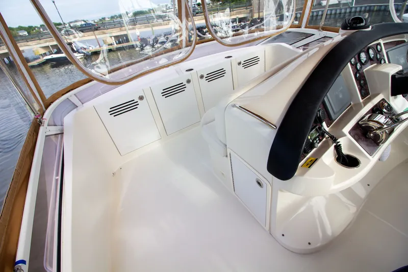 Slide: The Image of The image shows the cockpit of a 2006 Carver 33 Super Sport with modern instruments. - 44