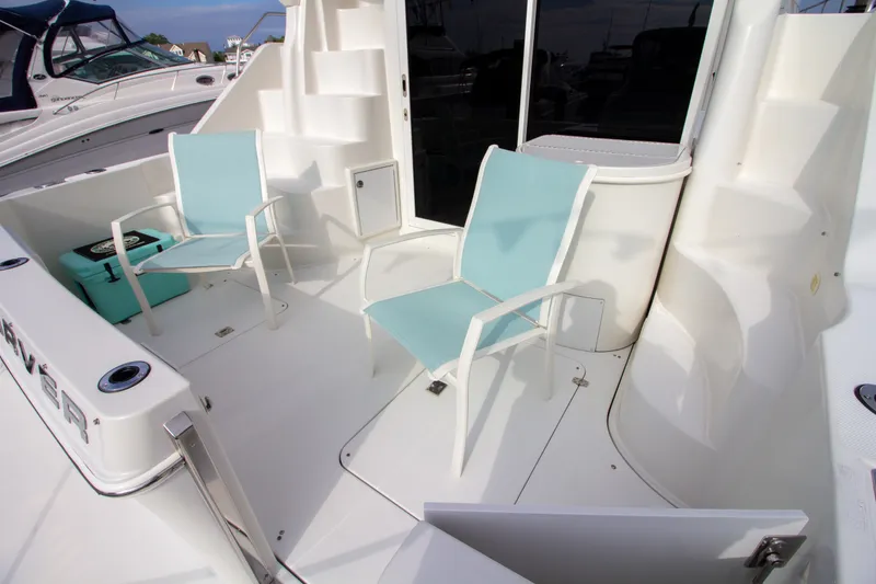 Slide: The Image of The image shows the cockpit of a 2006 Carver 33 Super Sport with two blue chairs. - 22