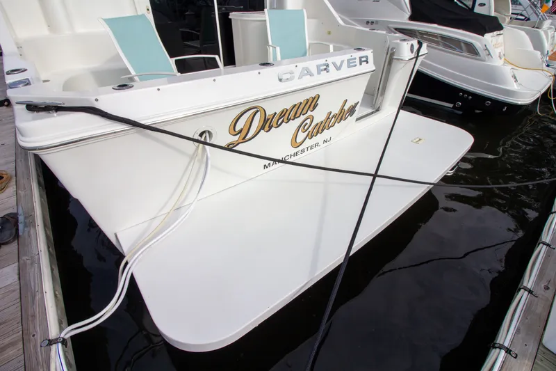 Slide: The Image of The stern of a 2006 Carver 33 Super Sport named "Dream Catcher" docked at a marina. - 21
