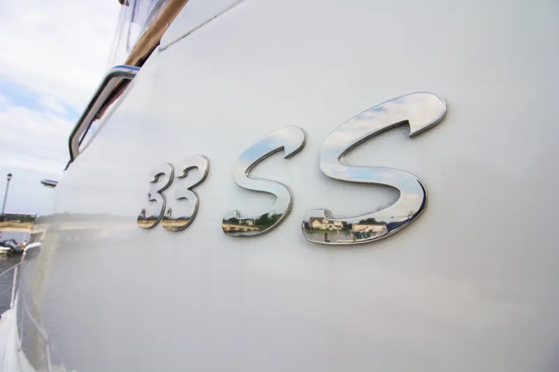 Slide: The Image of Close-up of the shiny "33 SS" lettering on the side of a boat. - 35