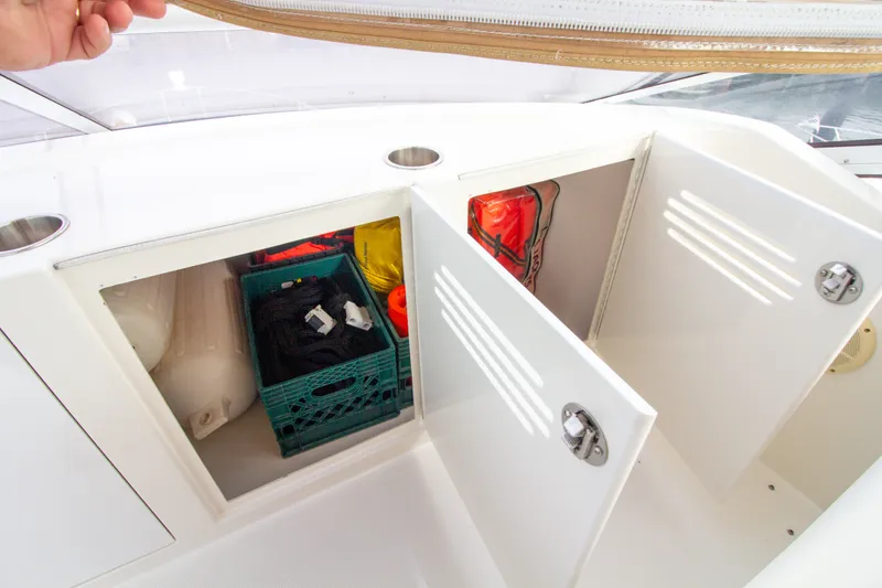 Slide: The Image of Storage area on a 2006 Carver 33 Super Sport boat with open cabinets and various items. - 47