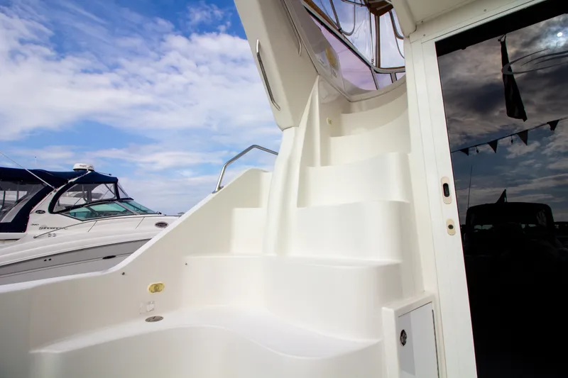 Slide: The Image of White stairs on a boat leading to an upper deck, with blue sky in the background. - 40