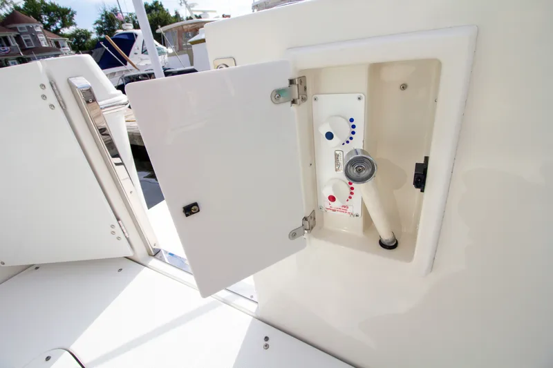 Slide: The Image of A white boat shower with hot and cold water, built into the boat's wall. - 27
