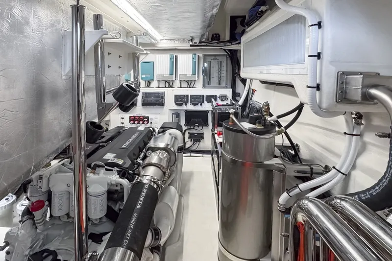 Slide: The Image of The engine room of the Riviera 5600 Sport Yacht Platinum Edition features complex engines and technical equipment. - 21