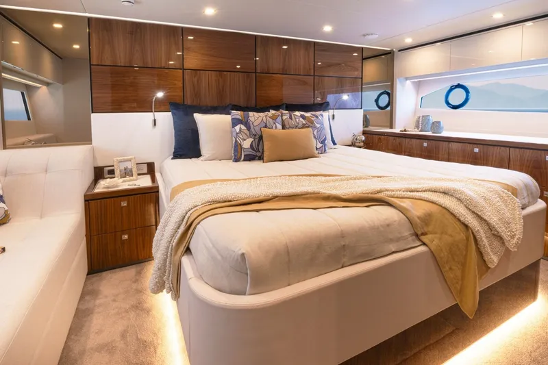 Slide: The Image of Luxurious bedroom with king-size bed, elegant wood paneling, and large windows in a yacht. - 13
