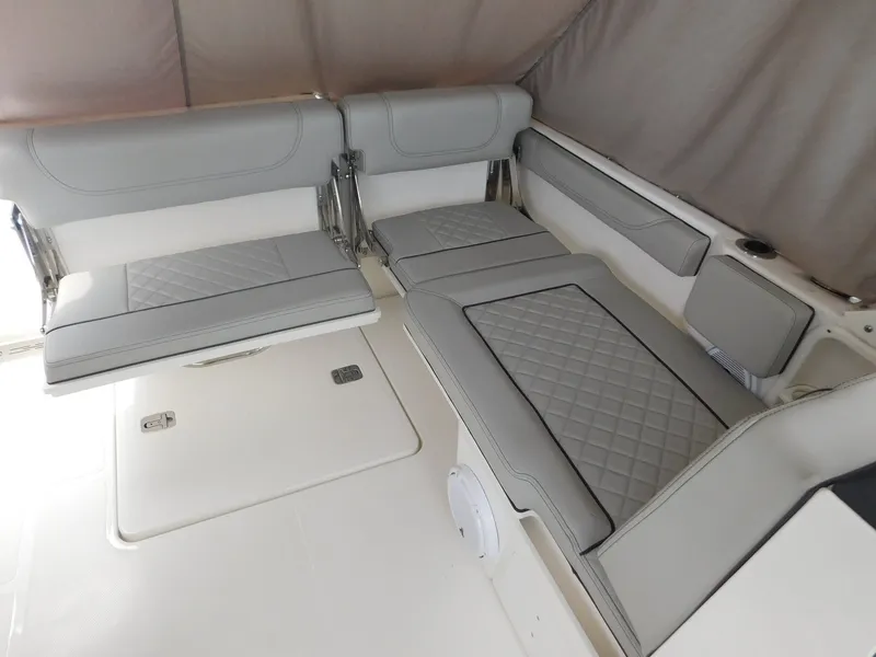 Slide: The Image of The image shows the interior of a Pursuit DC 246 Dual Console boat with gray upholstery. - 12