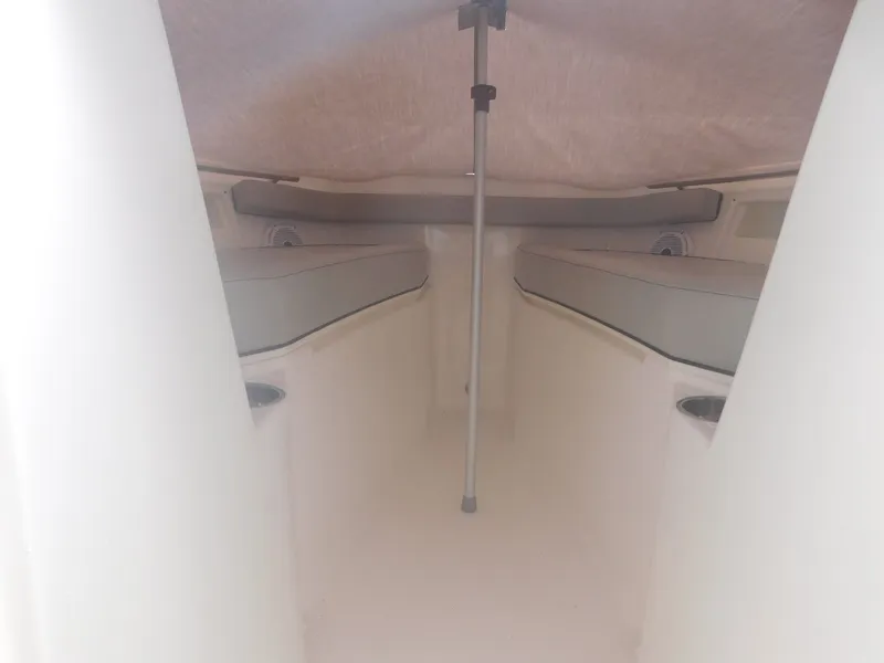 Slide: The Image of Interior view of the cabin with two cushioned benches and a support pole. - 8