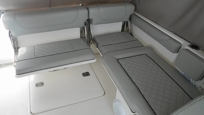 Slide: The Image of The interior of the 2023 Pursuit DC 246 Dual Console features gray, cushioned seats with a quilted pattern. - 11