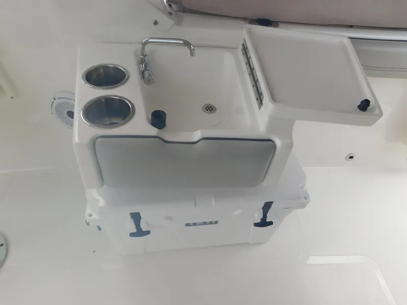 Slide: The Image of A white boat with a small sink, two cup holders, and a work surface. - 10