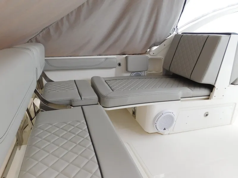 Slide: The Image of Interior view of a 2023 Pursuit DC 246 Dual Console boat with gray upholstered seating. - 14