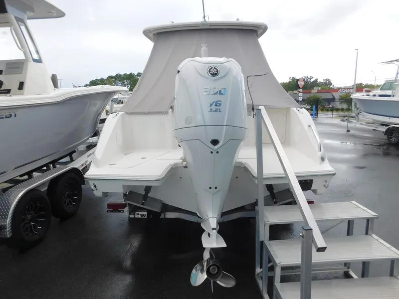 Slide: The Image of A 2023 Pursuit DC 246 Dual Console boat with a powerful outboard motor. - 3