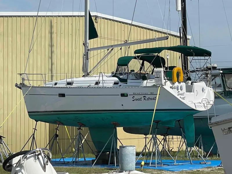 Slide: The Image of 2004 Beneteau 361 sailboat "Sweet Retreat" on stands near a yellow building. - 29