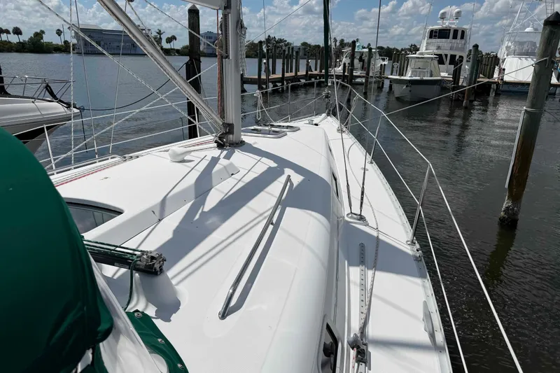 Slide: The Image of 2004 Beneteau 361 sailboat docked at marina, showcasing deck and rigging. - 27