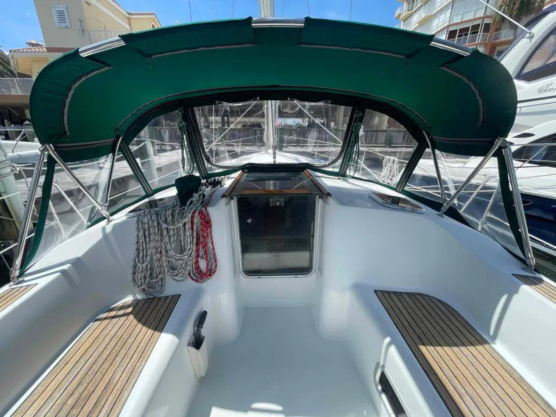 Slide: The Image of 2004 Beneteau 361 sailboat cockpit with green canopy and neatly coiled ropes. - 22