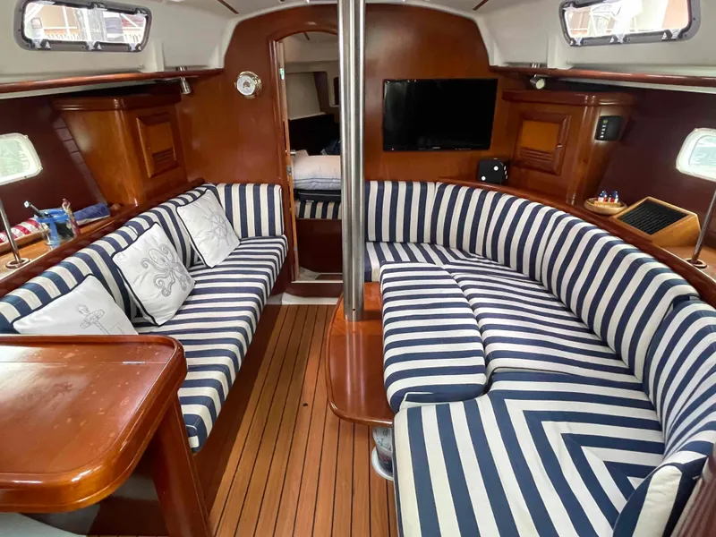 Slide: The Image of Luxurious 2004 Beneteau 361 yacht interior with striped seating and elegant wood finish. - 4