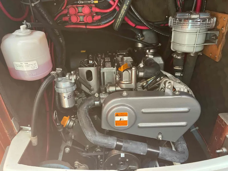Slide: The Image of Engine compartment of a 2004 Beneteau 361 sailboat, showcasing mechanical components and wiring. - 51