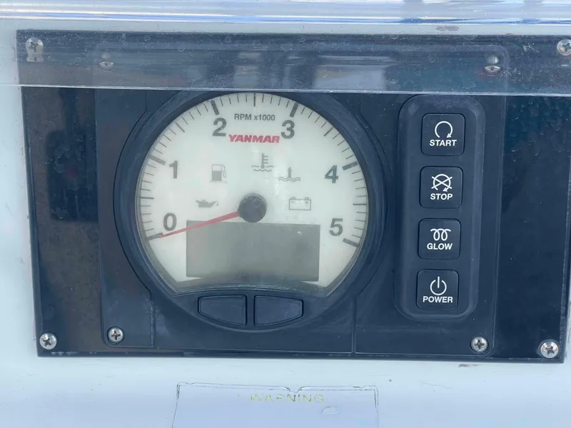 Slide: The Image of Control panel of a 2004 Beneteau 361 sailboat with Yanmar tachometer and buttons. - 37