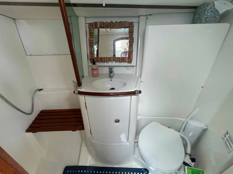 Slide: The Image of Bathroom of 2004 Beneteau 361 yacht with sink, mirror, and toilet. - 7