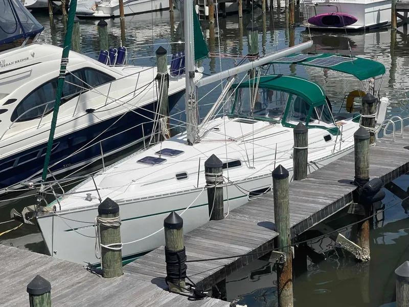 Slide: The Image of 2004 Beneteau 361 sailboat docked at marina with green canopy. - 31
