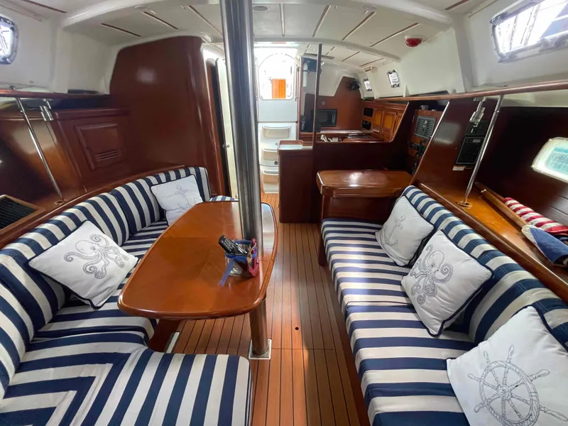 Slide: The Image of Interior of 2004 Beneteau 361 sailboat with striped seating and nautical decor. - 8