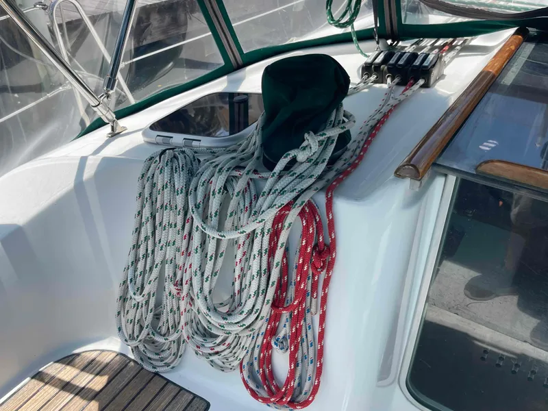 Slide: The Image of Coiled ropes on 2004 Beneteau 361 sailboat deck, near cockpit controls. - 38
