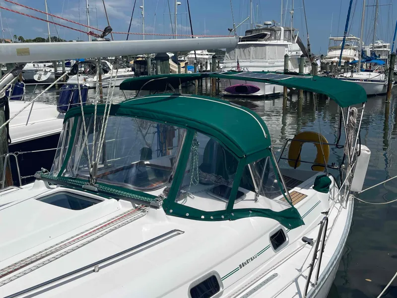 Slide: The Image of 2004 Beneteau 361 sailboat with green canopy docked at marina. - 34