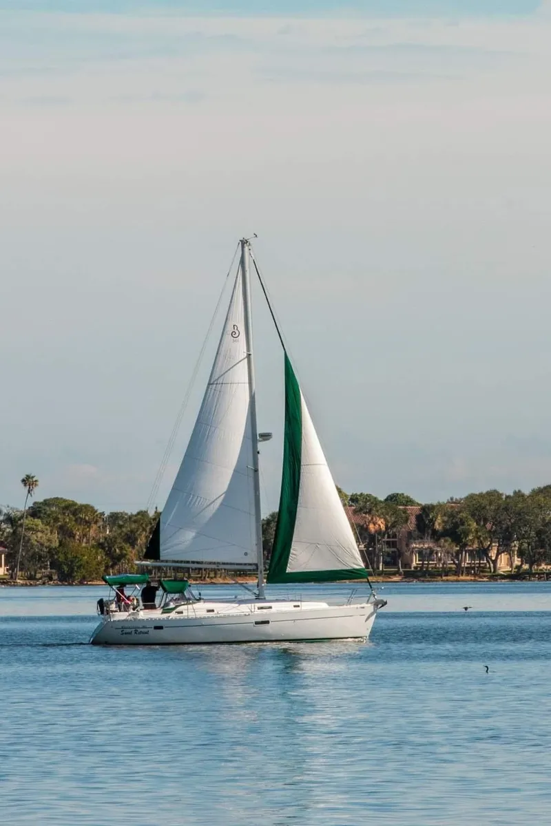 Slide: The Image of Sailing yacht Beneteau 361, 2004 model, cruising on calm waters with green and white sails. - 28