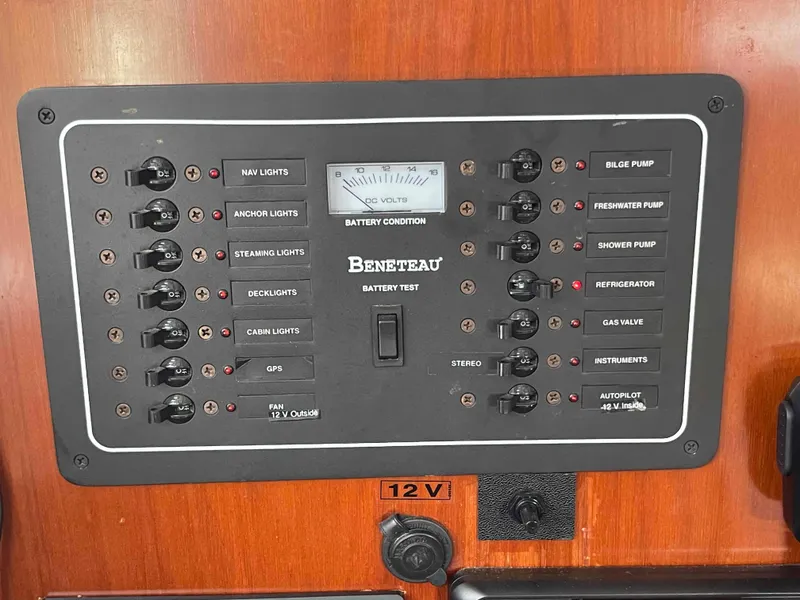 Slide: The Image of Control panel of a 2004 Beneteau 361 sailboat, featuring various switches and battery condition meter. - 45
