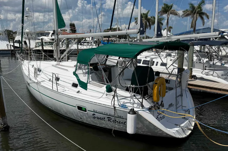 The Image of 2004 Beneteau 361 sailboat docked at marina with green canopy and clear skies. - 0