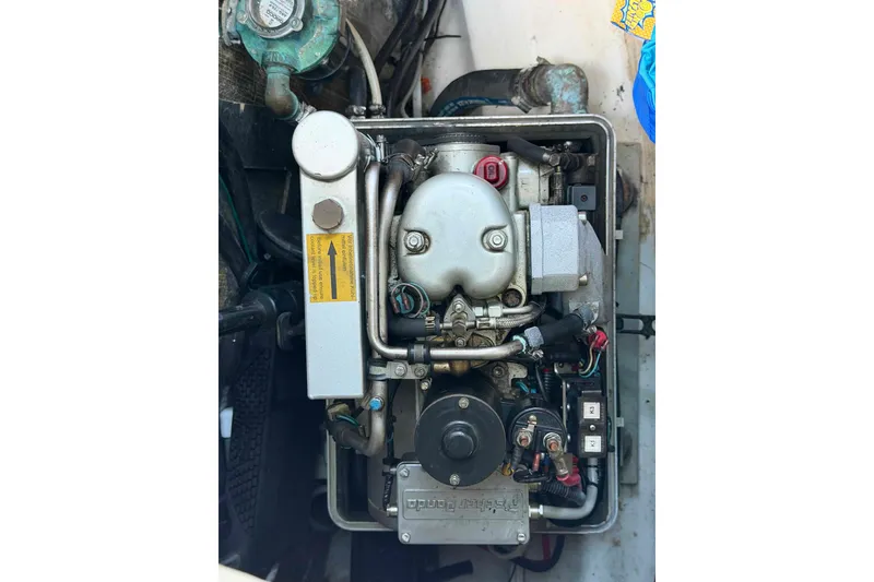 Slide: The Image of Engine of a 2004 Beneteau 361 sailboat, showcasing mechanical components and wiring. - 70