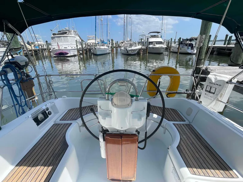 Slide: The Image of Cockpit view of 2004 Beneteau 361 sailboat docked at marina with clear skies. - 39