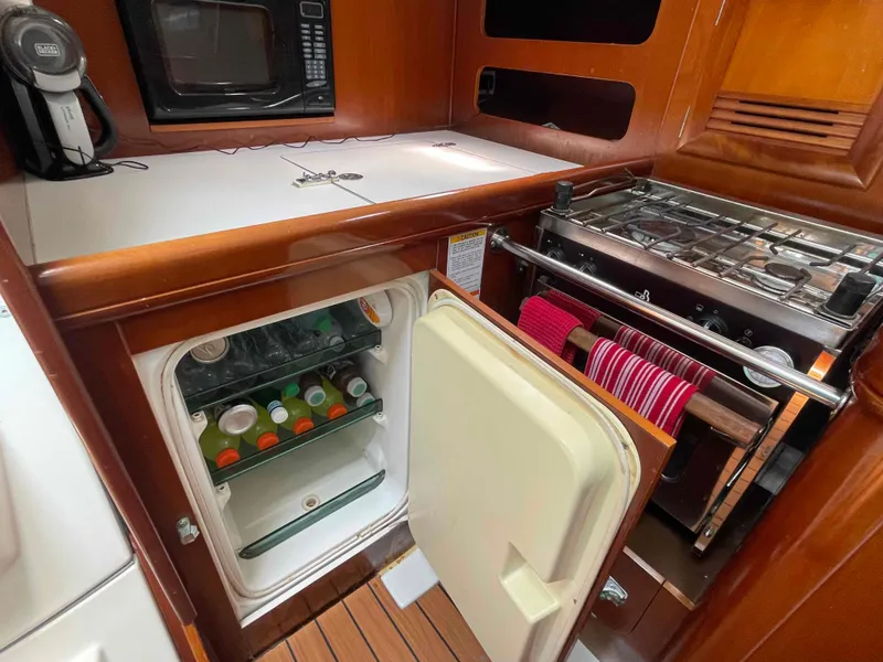 Slide: The Image of Galley kitchen in 2004 Beneteau 361 yacht with fridge, stove, and microwave. - 15