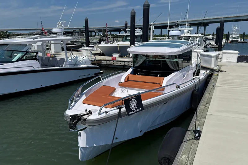 The Image of 2026 Axopar 29 XC Cross Cabin docked at marina, featuring sleek design and modern amenities. - 0
