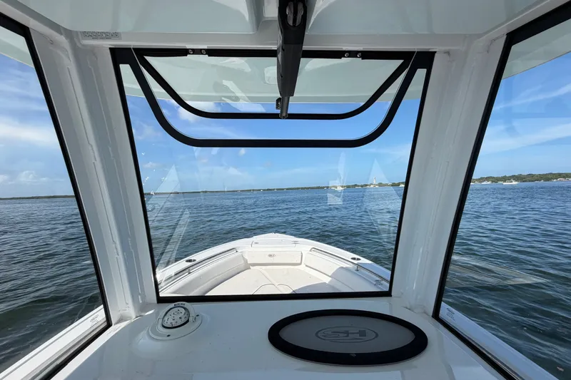 Slide: The Image of Interior view from a 2022 Sea Hunt Ultra 239SE boat, overlooking calm waters. - 26