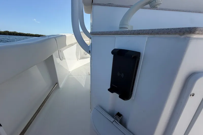 Slide: The Image of 2022 Sea Hunt Ultra 239SE boat interior with phone holder and sleek design. - 49