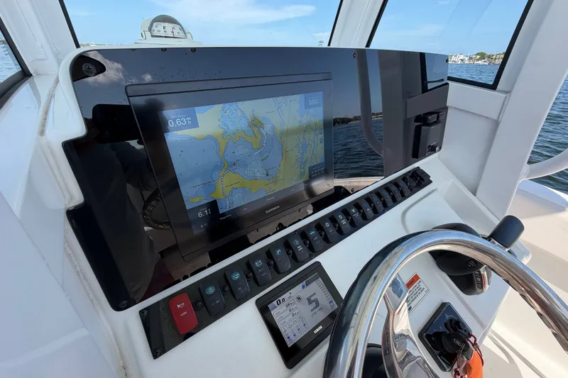 Slide: The Image of Dashboard of 2022 Sea Hunt Ultra 239SE boat with navigation display and controls. - 21