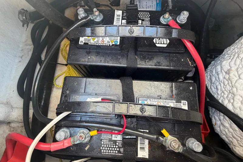Slide: The Image of Dual marine batteries in a 2022 Sea Hunt Ultra 239SE boat. - 55