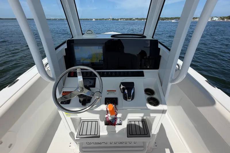 Slide: The Image of 2022 Sea Hunt Ultra 239SE boat dashboard with steering wheel and navigation display. - 18