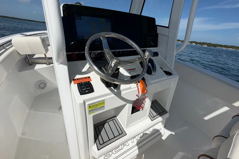 Slide: The Image of 2022 Sea Hunt Ultra 239SE boat console with steering wheel and navigation system. - 31