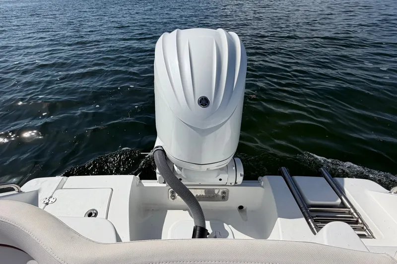Slide: The Image of 2022 Sea Hunt Ultra 239SE boat with outboard motor on water. - 44