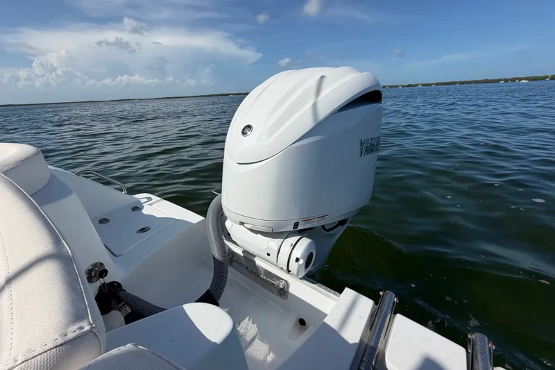 Slide: The Image of 2022 Sea Hunt Ultra 239SE boat with Yamaha outboard motor on calm water. - 37