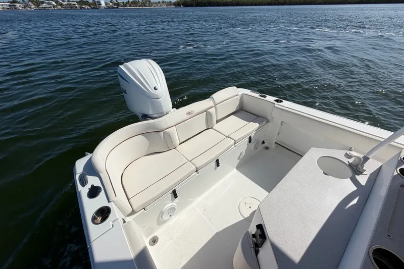 Slide: The Image of 2022 Sea Hunt Ultra 239SE boat interior with seating and outboard motor on water. - 38