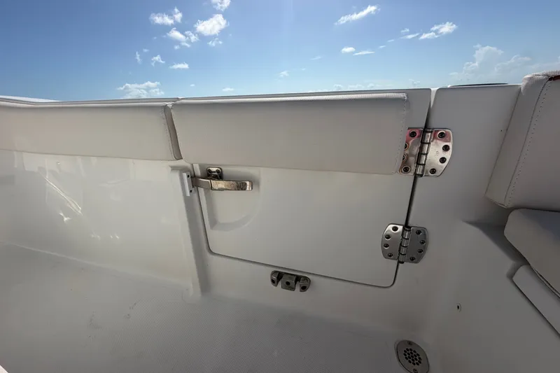 Slide: The Image of 2022 Sea Hunt Ultra 239SE boat interior with white seating and stainless steel hardware. - 47