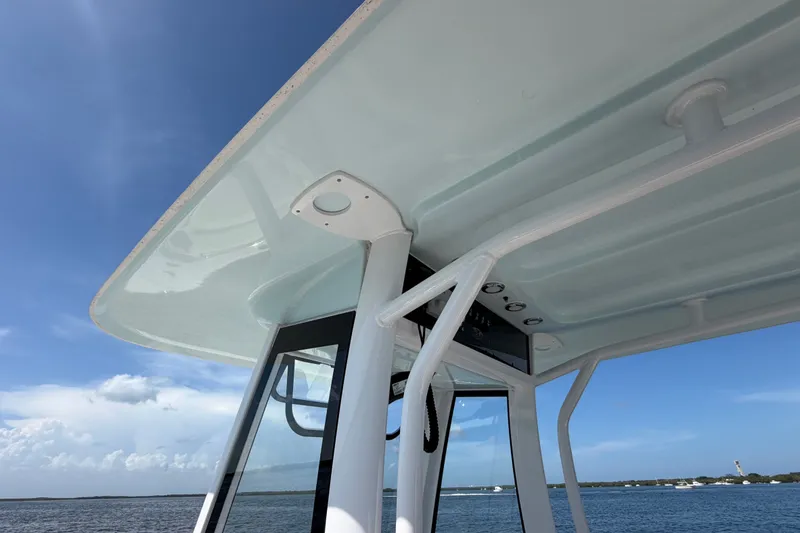 Slide: The Image of 2022 Sea Hunt Ultra 239SE boat canopy with ocean view and clear sky. - 14