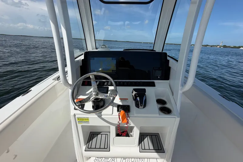 Slide: The Image of 2022 Sea Hunt Ultra 239SE boat dashboard with steering wheel and navigation system. - 30