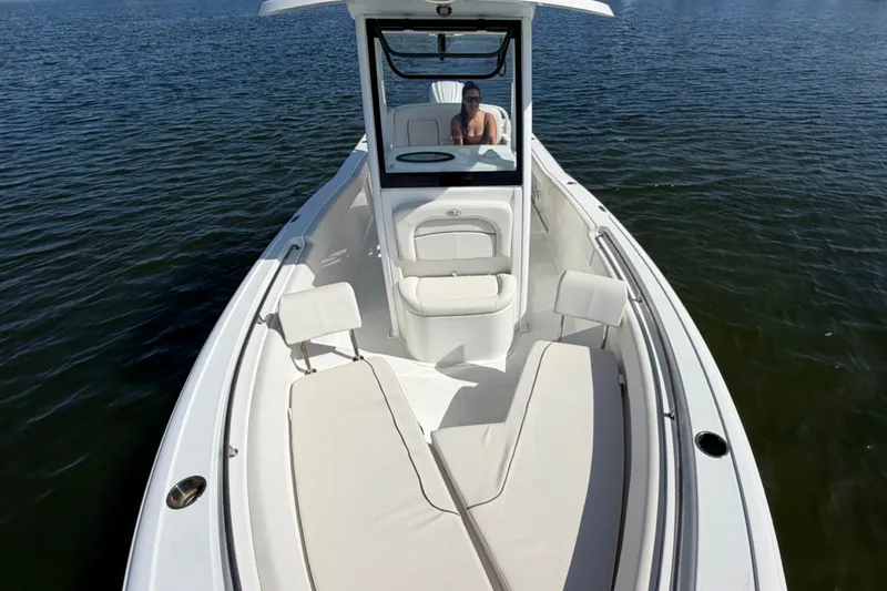 Slide: The Image of 2022 Sea Hunt Ultra 239SE boat on water, featuring spacious seating and sleek design. - 11