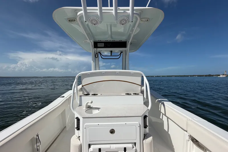 Slide: The Image of 2022 Sea Hunt Ultra 239SE boat on open water under clear blue sky. - 40