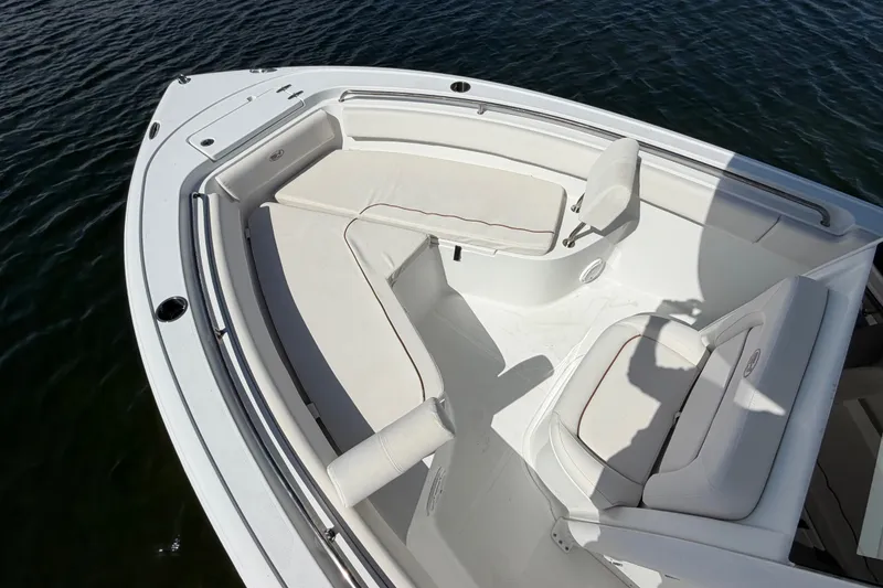 Slide: The Image of 2022 Sea Hunt Ultra 239SE boat interior with cushioned seating and sleek design. - 9