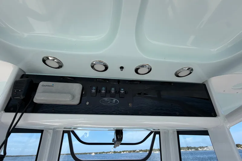 Slide: The Image of 2022 Sea Hunt Ultra 239SE dashboard with Garmin device and control panel. - 19